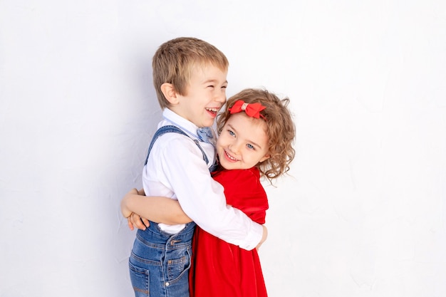 The boy hugs the girl, the child's concept of friendship and love