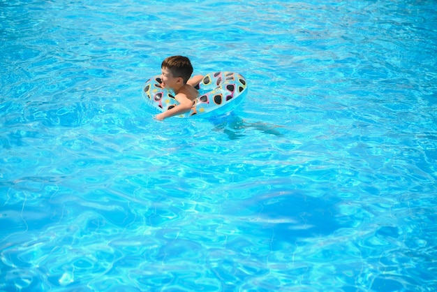 Boy on inflatable rubber circle.