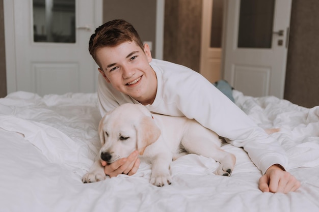 boy is fooling around with a pet in the room space for text High quality photo