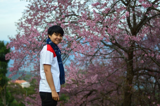 Boy is happy to see the cherry blossoms.