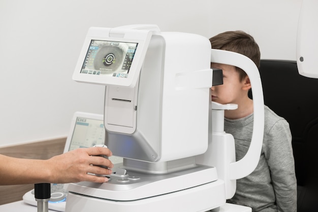 The boy is the patient on reception at doctor ophthalmologist Diagnostic ophthalmologic equipment