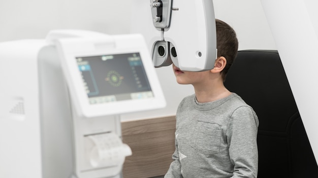 The boy is the patient on reception at doctor ophthalmologist Diagnostic ophthalmologic equipment