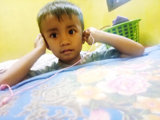 boy is playing msic on earphone