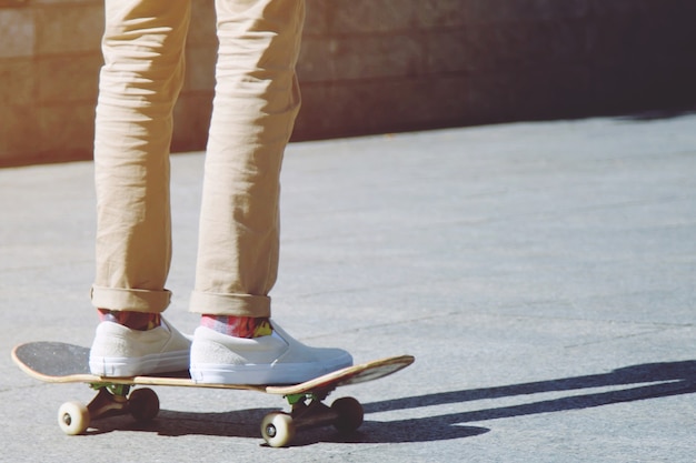 A boy is  playing skateboard in the park