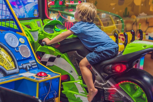 The boy is playing a slot machine.