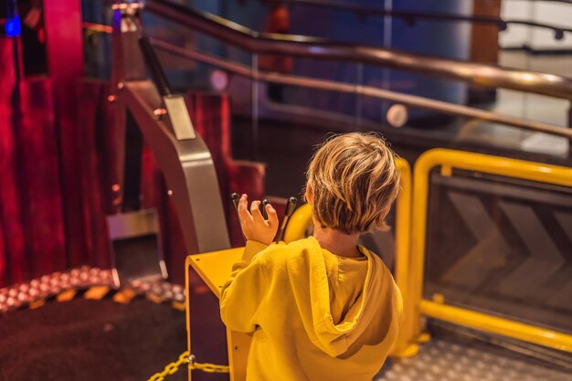 The boy is playing with a big toy excavator Construction concept Child development concept