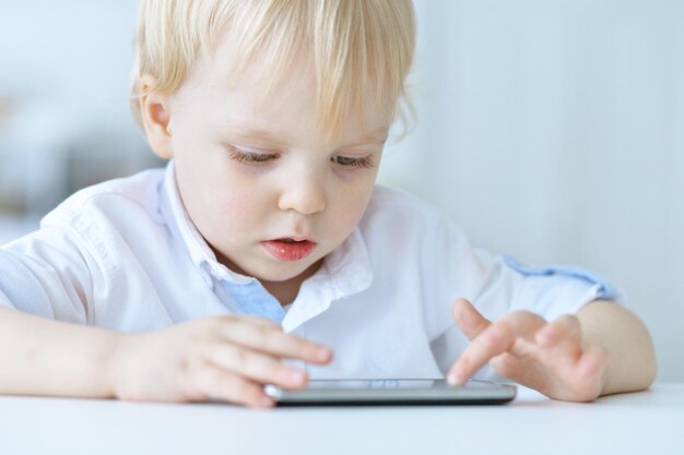 Boy is playing with a mobile phone