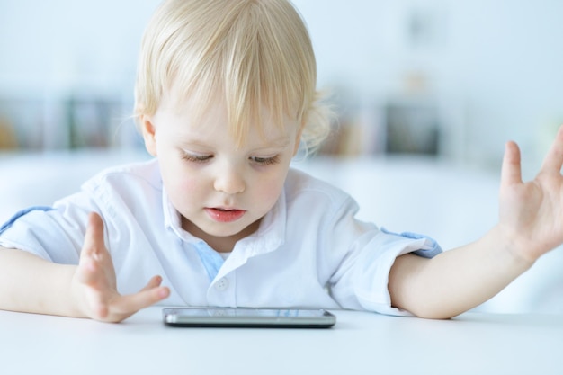 少年は携帯電話で遊んでいます