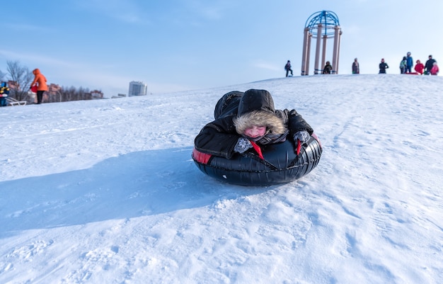 The boy is riding a tubing