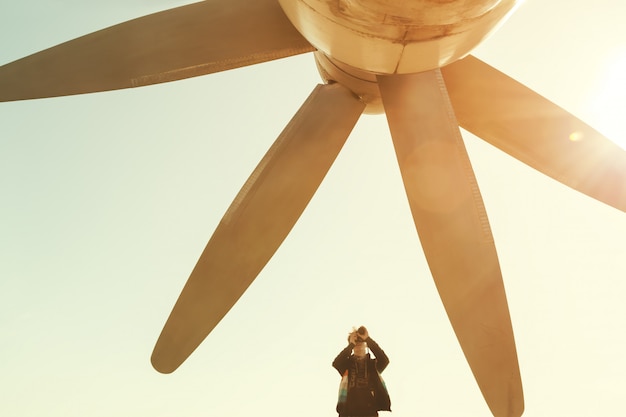 Boy is taking photo of a huge propeller