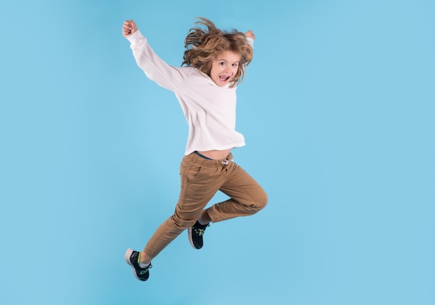 Boy jumping Full size of kid boy have fun jump up isolated over blue background