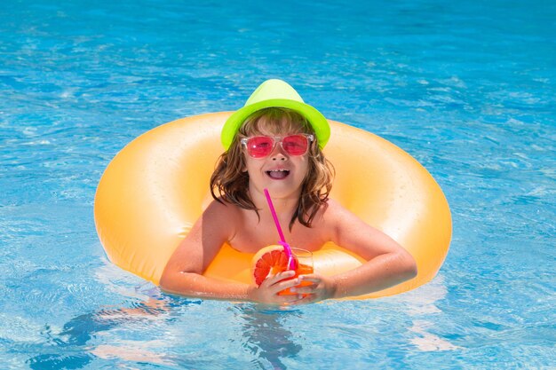 Boy kid in pool drinking cocktail happy lifestyle kids water toy healthy outdoor activity for childr