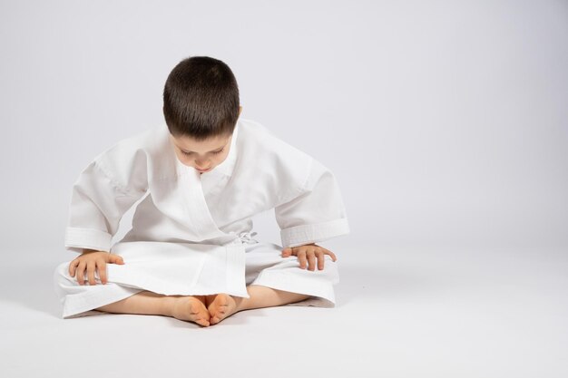 A boy in a kimono practices karate