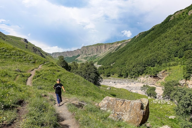 Boy at the KyzylKol River surrounded by the Caucasus Mountains near Elbrus Jilysu Russia