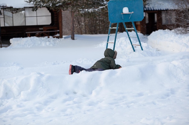 A boy laying in the snow