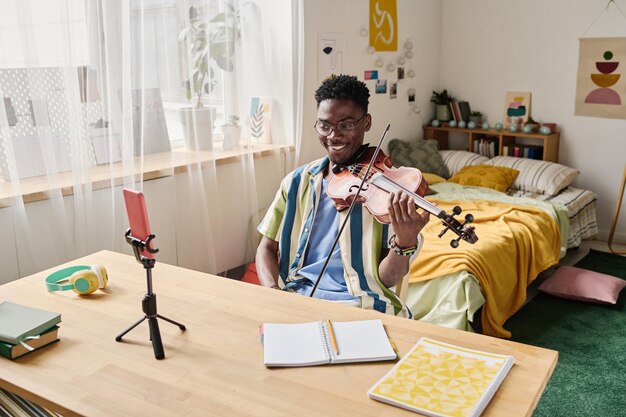 Boy learning to play violin online