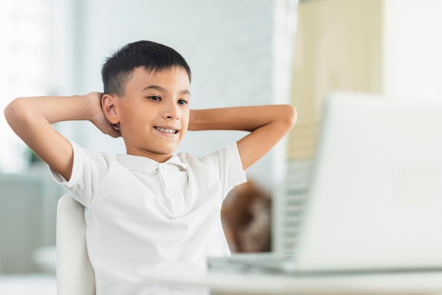 Boy looking at laptopRelaxing and watch videoStudy online