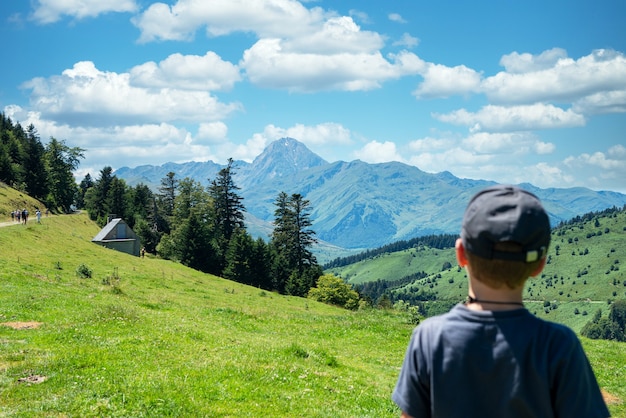 A boy looking Pic du Midi de Bigorre in the french Pyrenees mountains