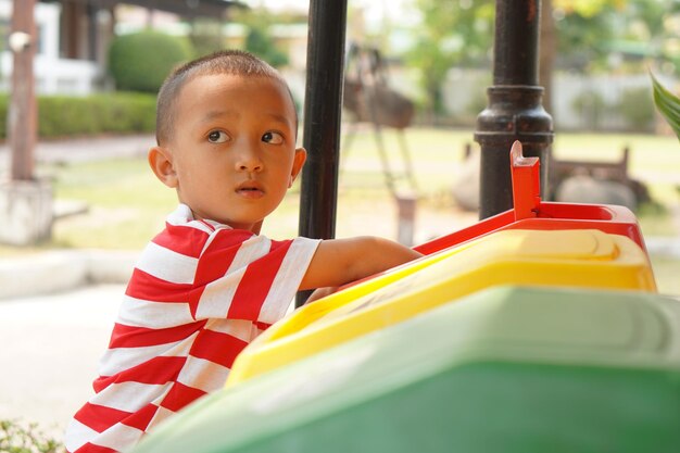 Boy looking at trash cans in the garden