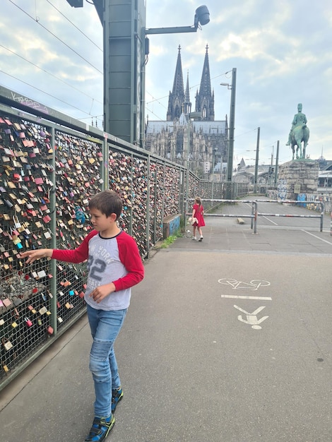 A boy looks at the graffiti on the bridge.