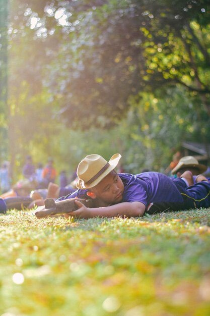 Boy lying on field in park