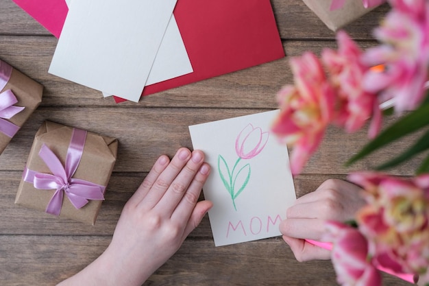 The boy makes a card for mother's day Children's drawings