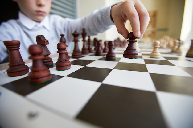 Boy making chess move