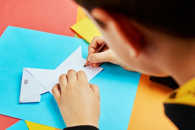 Boy making paper dog origami