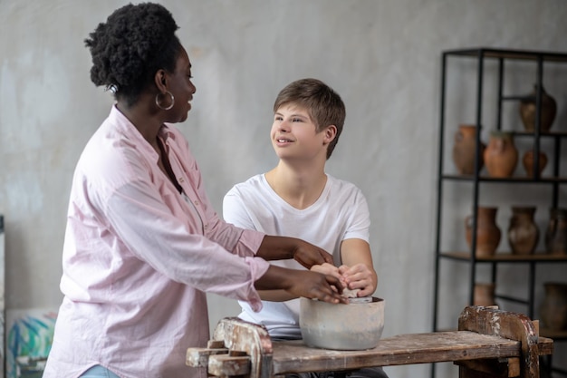 A boy making a pot in an art studio