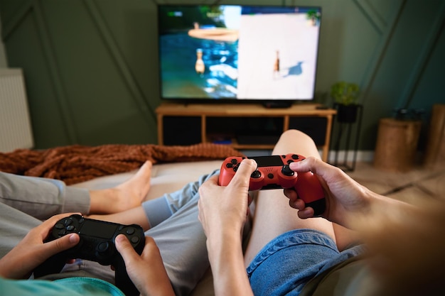 Boy and man playing video game at home