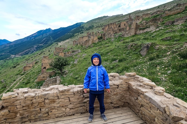 A boy on medieval defensive towers in the village of Goor Russia Dagestan 2021