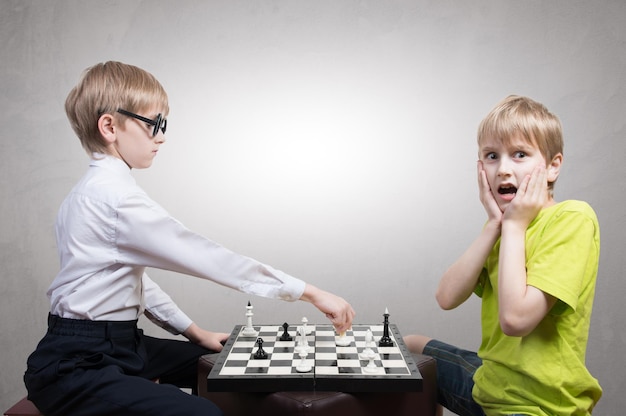 Boy and nerd playing chess