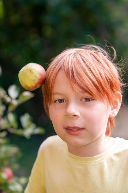 Boy of nine years old in an apple orchard