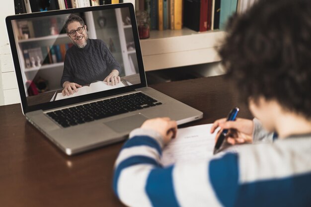 Boy during online lesson on laptop