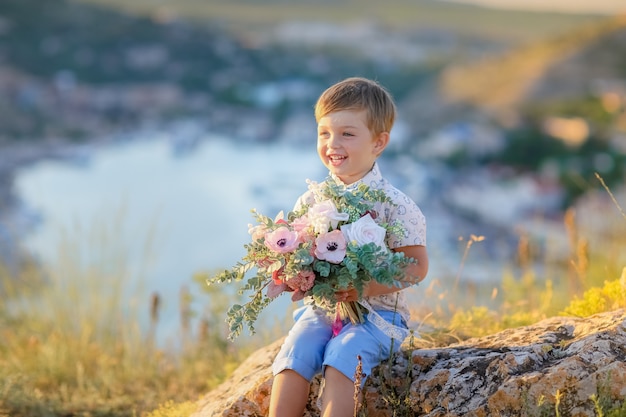 Boy outdoors with a bouquet of flowers