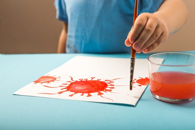 Boy painting with watercolor a molecule of coronavirus. World health coronavirus outbreak  global deadly  coronaviruses influenza