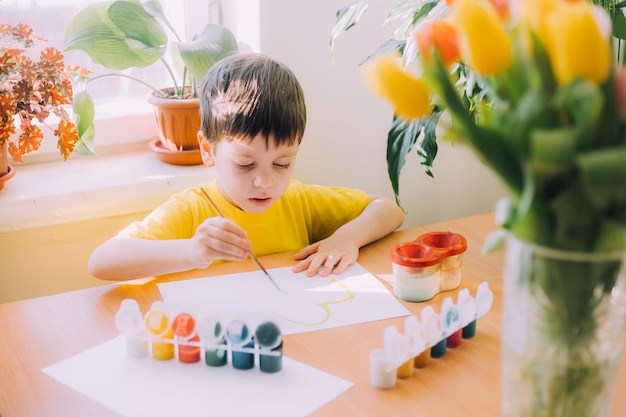 The boy paints a lifestyle Children's hobby Leisure at home Children's drawings Psychology of children's drawings