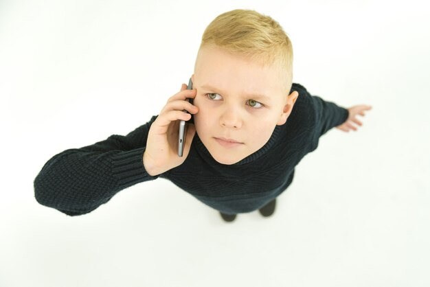 The boy phone on the white background. View from above