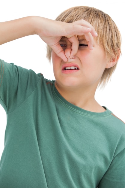 Boy pinching his nose 