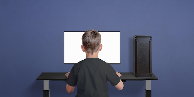 Boy play game on desktop computer Children in gaming Isolated monitor display for video game promotion Copy space beside