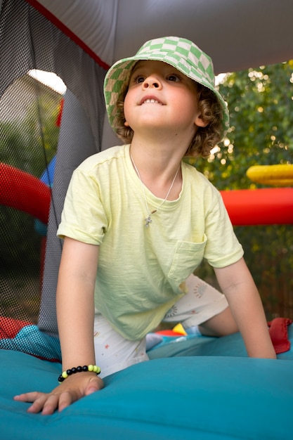 Boy playing in bounce house low angle