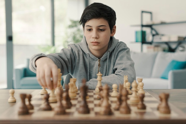 Boy playing chess at home