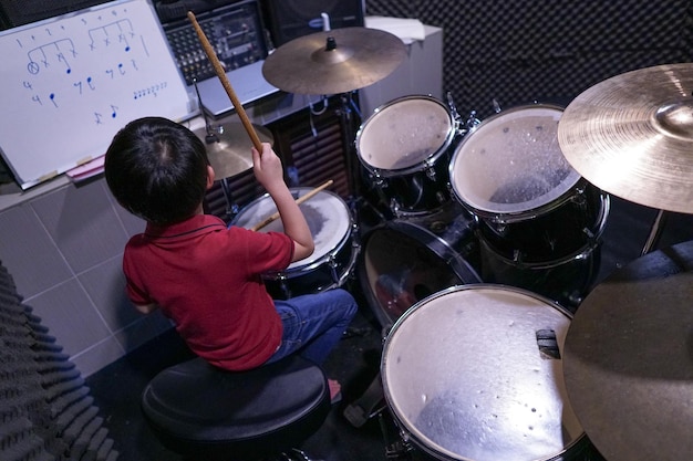 Boy playing drum in studio