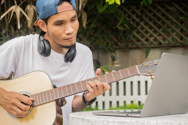 Boy playing guitar at hom