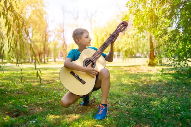 Boy playing guitar in the park