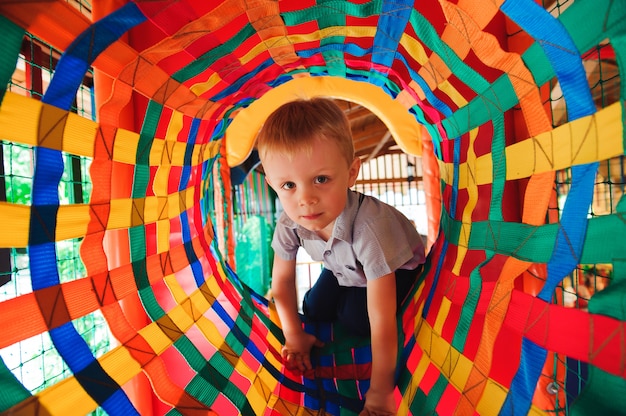 Boy playing on the playground, in the children's maze