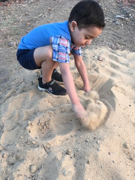 Boy playing on sand