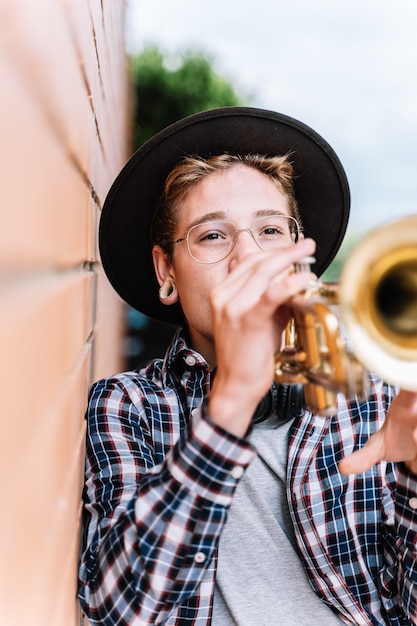 boy playing the trumpet in the street