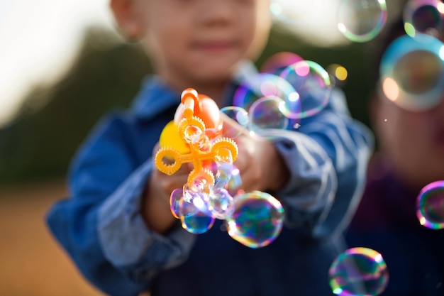 Photo boy playing with bubble wand