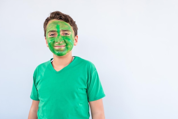 Boy playing with colors using his hands and his face